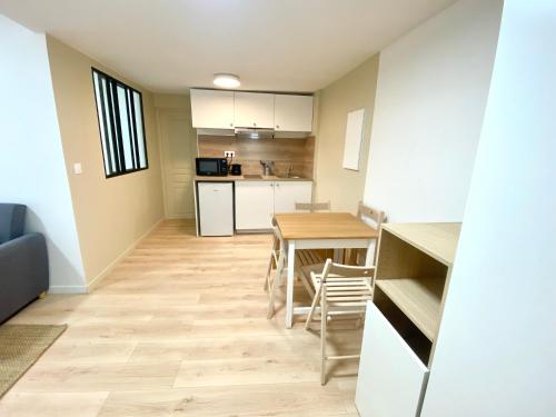 une cuisine et une salle à manger avec une table et des chaises dans l'établissement Charmant appartement à Herblay centre, proche gare, 22 min de Paris St Lazare, à Herblay