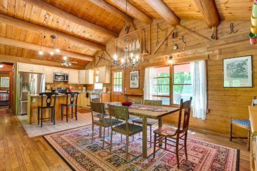 a kitchen and dining room with a table and chairs at Updated Mtn Cabin on 20 Acres with Large Waterfall in Jasper