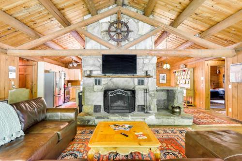 a living room with a couch and a fireplace at Updated Mtn Cabin on 20 Acres with Large Waterfall in Jasper