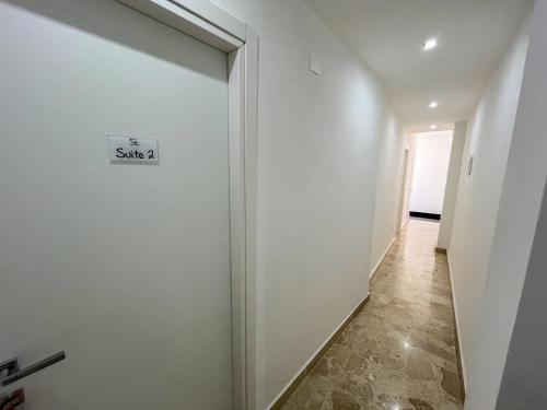 a hallway with a door with a sign on it at Suite Costa Sicana in Siculiana