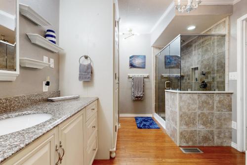 a bathroom with a shower and a sink at Little River Bend Abode in Mabank
