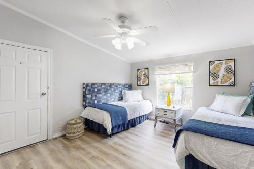 a bedroom with two beds and a ceiling fan at Little River Bend Abode in Mabank