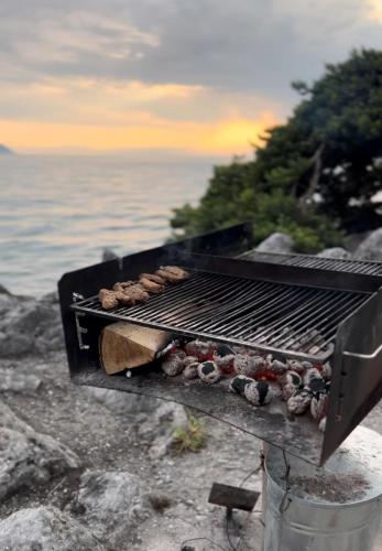 a grill with a bunch of food on it at Close to Lake & Chillon Castle, New & Comfortable in Veytaux