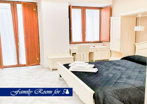 a bedroom with a bed and a desk and windows at Bed & Breakfast Medea in Naples