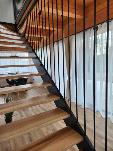 a staircase in a house with wood and metal railings at bystřice park Chata Voda in Včelákov