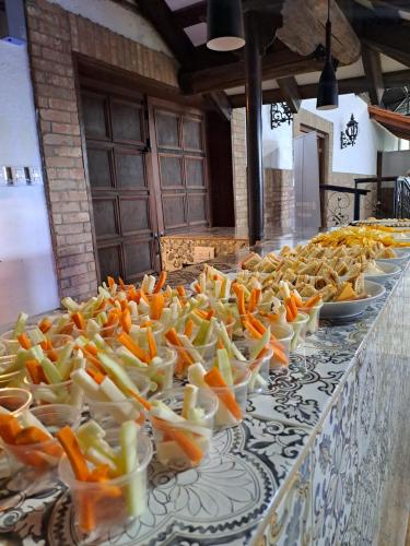 a row of bowls of food on a table at Hotel Quinta Mision in Creel
