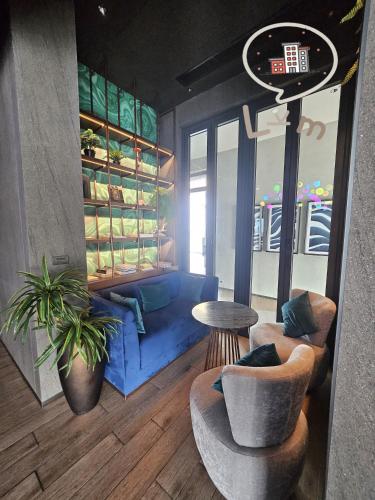 a living room with a blue couch and a table at The Central Pattaya High Floor, Pattaya City in Pattaya Central