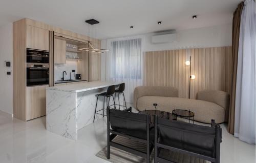 a kitchen and living room with a table and chairs at Beautiful Apartment In Novi Vinodolski in Novi Vinodolski