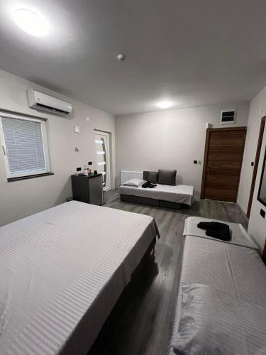 a bedroom with two beds and a couch at Edelweiss Villa Trpejca in Ohrid