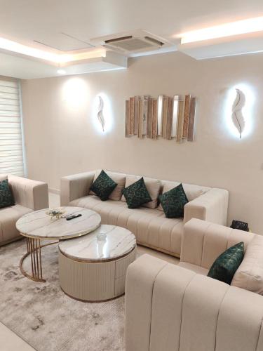 a living room with a couch and a table at Penta Square Apartments - PK LHR in Lahore