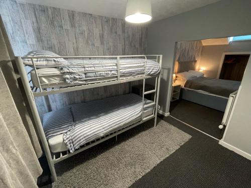 a room with two bunk beds and a bed at The Sefton Blackpool in Blackpool