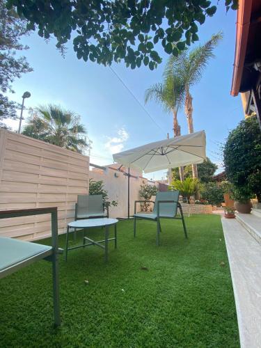 a yard with two chairs and an umbrella at Villa Ginevra in Taranto