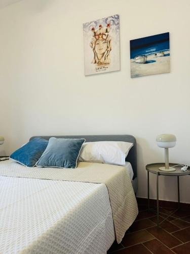 a bedroom with a bed and two pictures on the wall at Villa Ginevra in Taranto