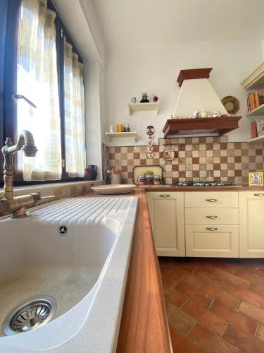 a kitchen with a large sink and a window at Villa Ginevra in Taranto