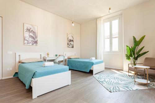 a bedroom with two beds and a couch at LAKE A DREAM for family free private parking in Arona