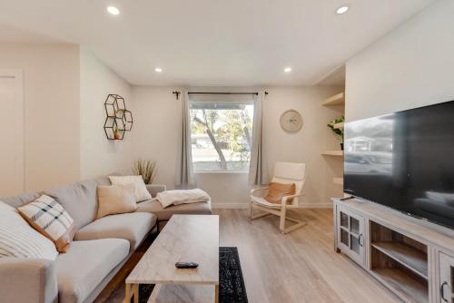 a living room with a couch and a flat screen tv at Forest Meadow Homestead in Dallas