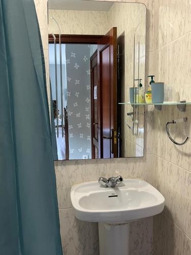a bathroom with a sink and a mirror at El pucheru 4 Almas in Barcenaciones