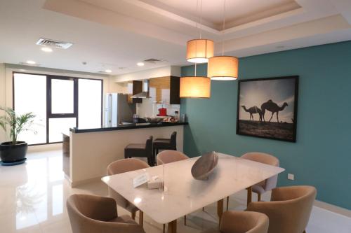 a dining room and kitchen with a table and chairs at Lagoona Beach Luxury Resort and Spa in Manama