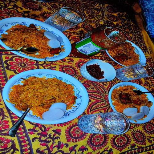 a table topped with plates of food on a table at HOTEL JOGI GUEST HOUSE welcome all families, friends, groups, couples, singles fully Airconditioner, attach washrooms, lift, wifi, 24 hours room service, power backup in Amritsar
