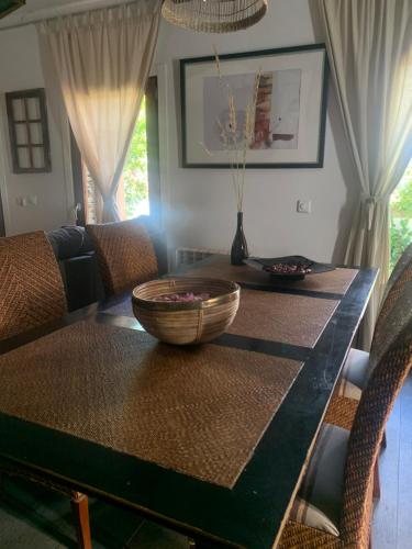 a dining room table with a bowl on top of it at La Cata Country House in Patones