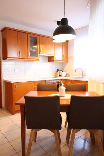 a kitchen with a wooden table with chairs and a dining room at Sailors Lodge - 3 min to beach in Pula