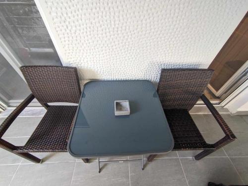 a blue table and two chairs in a room at 2 bedroom apartment for 4 people 42m from the sea in Perea