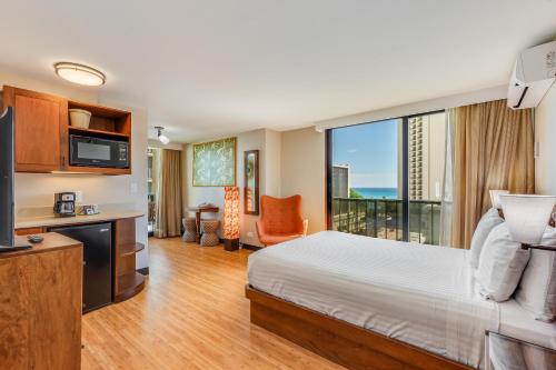 a hotel room with a bed and a large window at Castle Bamboo Waikīkī Hotel in Honolulu