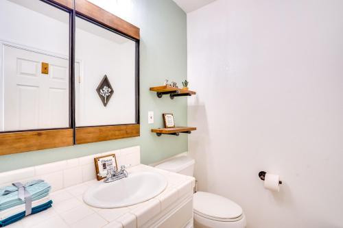 a bathroom with a sink and a toilet at Desert Escape - Hot Tub, Fire Pit and Grill in Landers