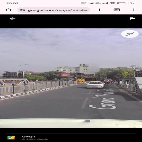 a car driving down a road with a view at HOTEL JOGI GUEST HOUSE welcome all families, friends, groups, couples, singles fully Airconditioner, attach washrooms, lift, wifi, 24 hours room service, power backup in Amritsar