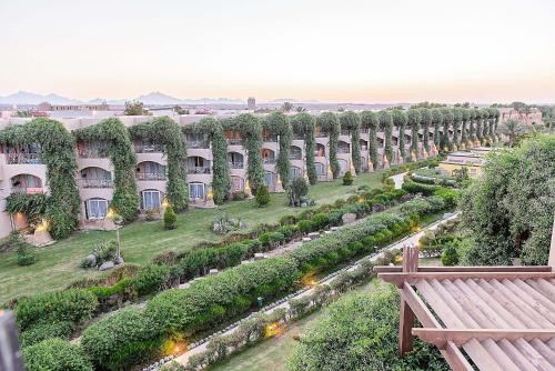 a long row of buildings with a garden at Salvatore Rooms-All Inclusive Makadi in Hurghada