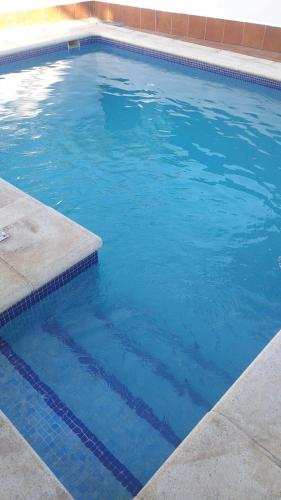 a large swimming pool with blue water at Poniente in Roche