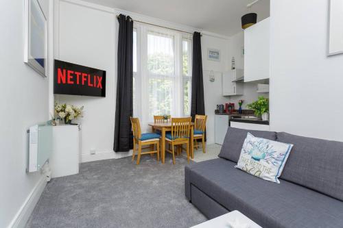 a living room with a couch and a table at Air Maison - Dockyard Dreams - Close To Gunwharf! in Portsmouth