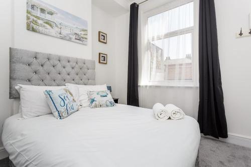 a bedroom with a white bed with a window at Air Maison - Dockyard Dreams - Close To Gunwharf! in Portsmouth