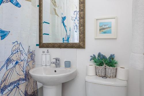 a bathroom with a sink and a toilet and a mirror at Air Maison - Dockyard Dreams - Close To Gunwharf! in Portsmouth
