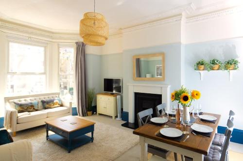 a living room with a table and a fireplace at Air Maison - Shore Stay in Portsmouth