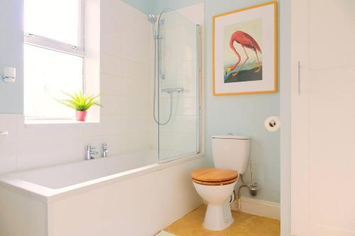a bathroom with a toilet and a glass shower at Air Maison - Shore Stay in Portsmouth