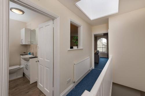 a hallway of a home with a door leading to a bathroom at St Jude's View in Portsmouth