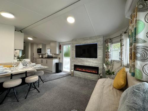 a living room with a couch and a fireplace at Elite Retreat Blackpool in Blackpool