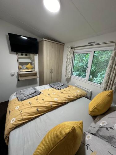 a bedroom with a large bed with a yellow comforter at Elite Retreat Blackpool in Blackpool