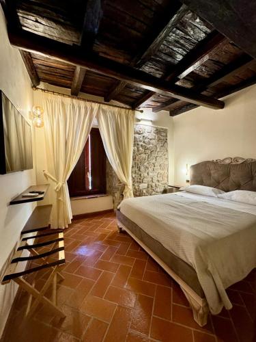 a bedroom with a bed and a stone wall at AL CARDINALE in Fondi