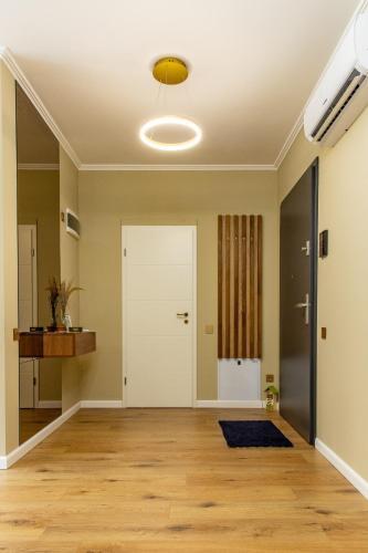 an empty living room with a door and a ceiling at Ophir Apartment Ultracentral,the greenest and brightest central area,3 parking space in the large yard in Cluj-Napoca