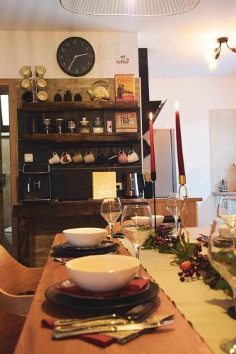 a table with bowls and wine glasses on it at Kuća za odmor Olympus in Vinica