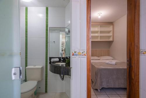 a small bathroom with a bed and a sink at ITNC143- Frente ao mar! Amplo ap com 3 quartos+3WC in Balneário Camboriú