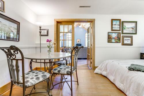 a dining room with a table and chairs and a bed at Secluded Ellsworth Apartment - Hiking Nearby! in Ellsworth
