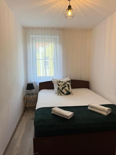 a bedroom with a bed with two towels on it at Blue Apartment close to Old Town in Bydgoszcz