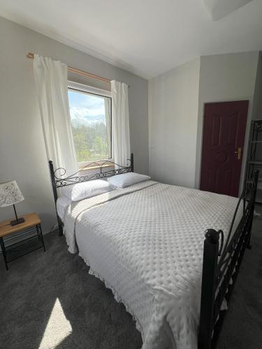 a bedroom with a large bed and a window at Jedliczanka in Jedlicze