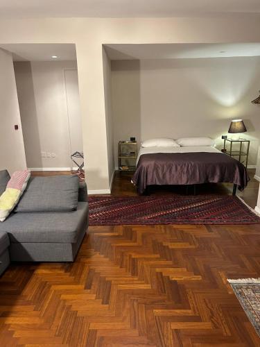a bedroom with a bed and a couch at MH Design Hotel in Naples