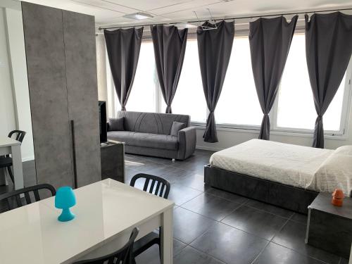 a bedroom with a bed and a couch and a table at Lake Garda Lovers Luxury in Peschiera del Garda