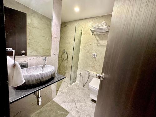 a bathroom with a sink and a toilet at TAKHT- Executive Suites and Rooms in Chinchiwad