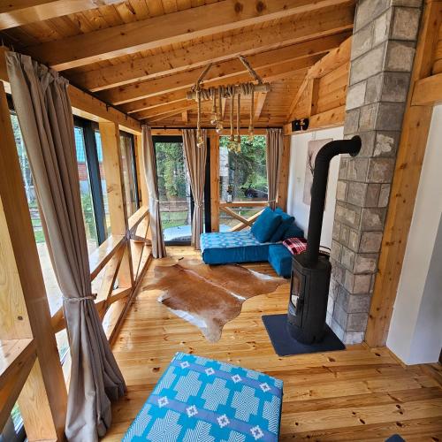 a living room with a fireplace in a house at Black Lake Chalet in Žabljak